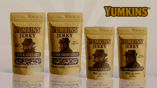Four packages of Yumkins Jerky on a reflective surface with a white background